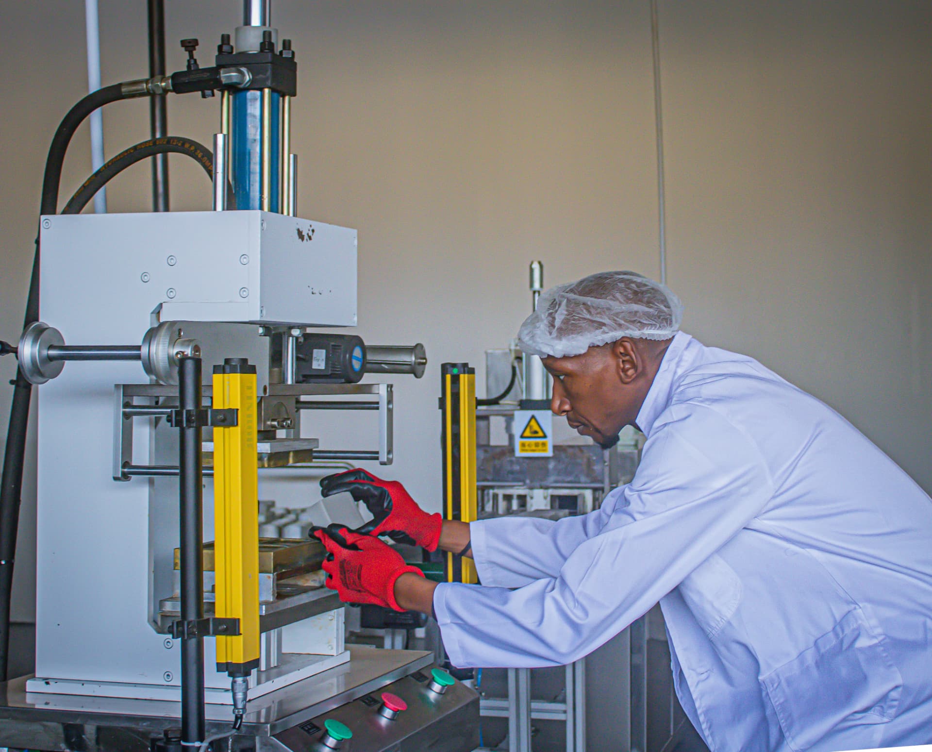 Technician operating the soap stamping press